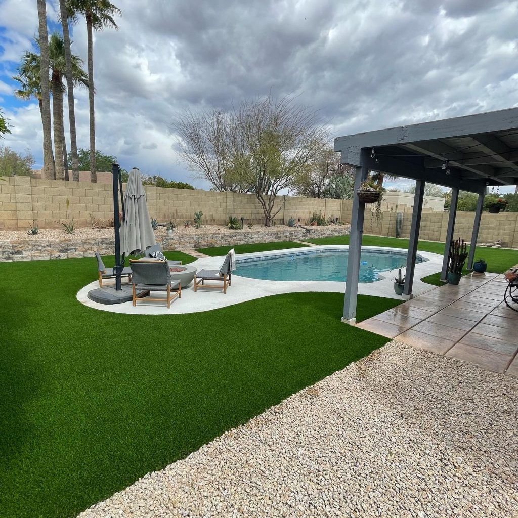 Backyard pool with turf lawn and covered patio