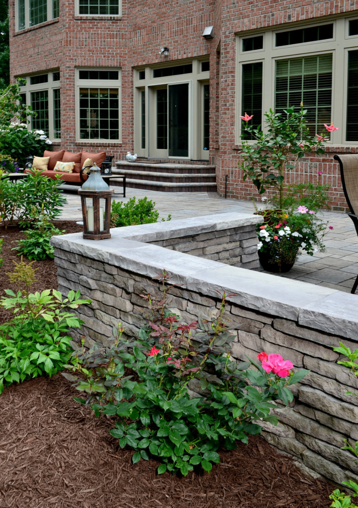 Stone retaining wall and paver patio