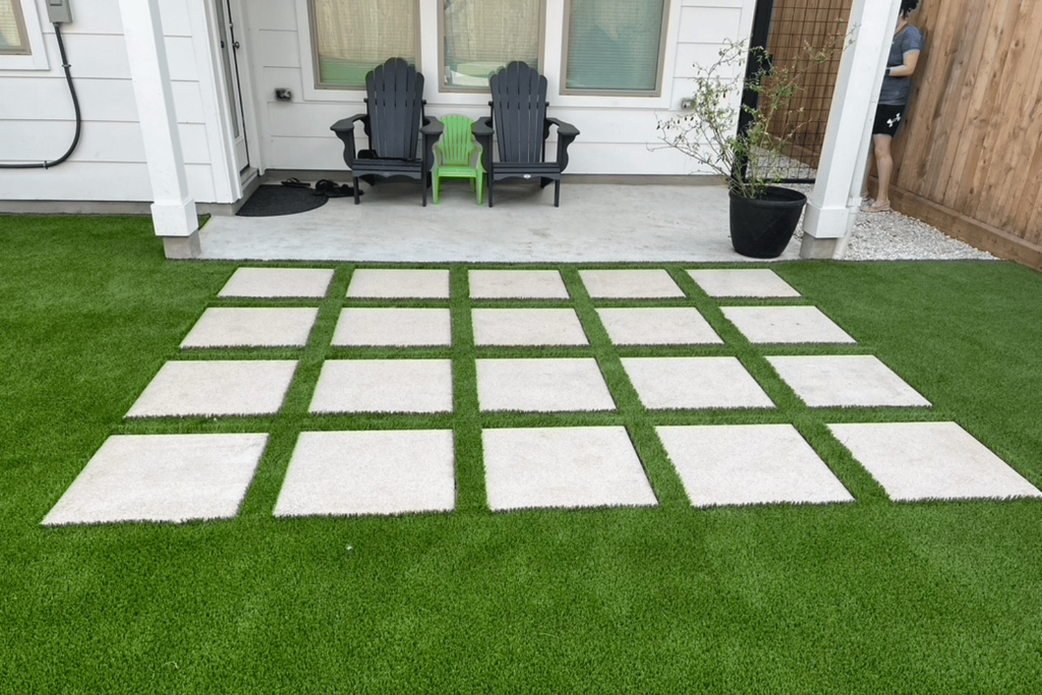 Artificial turf lawn with square paver stepping stones